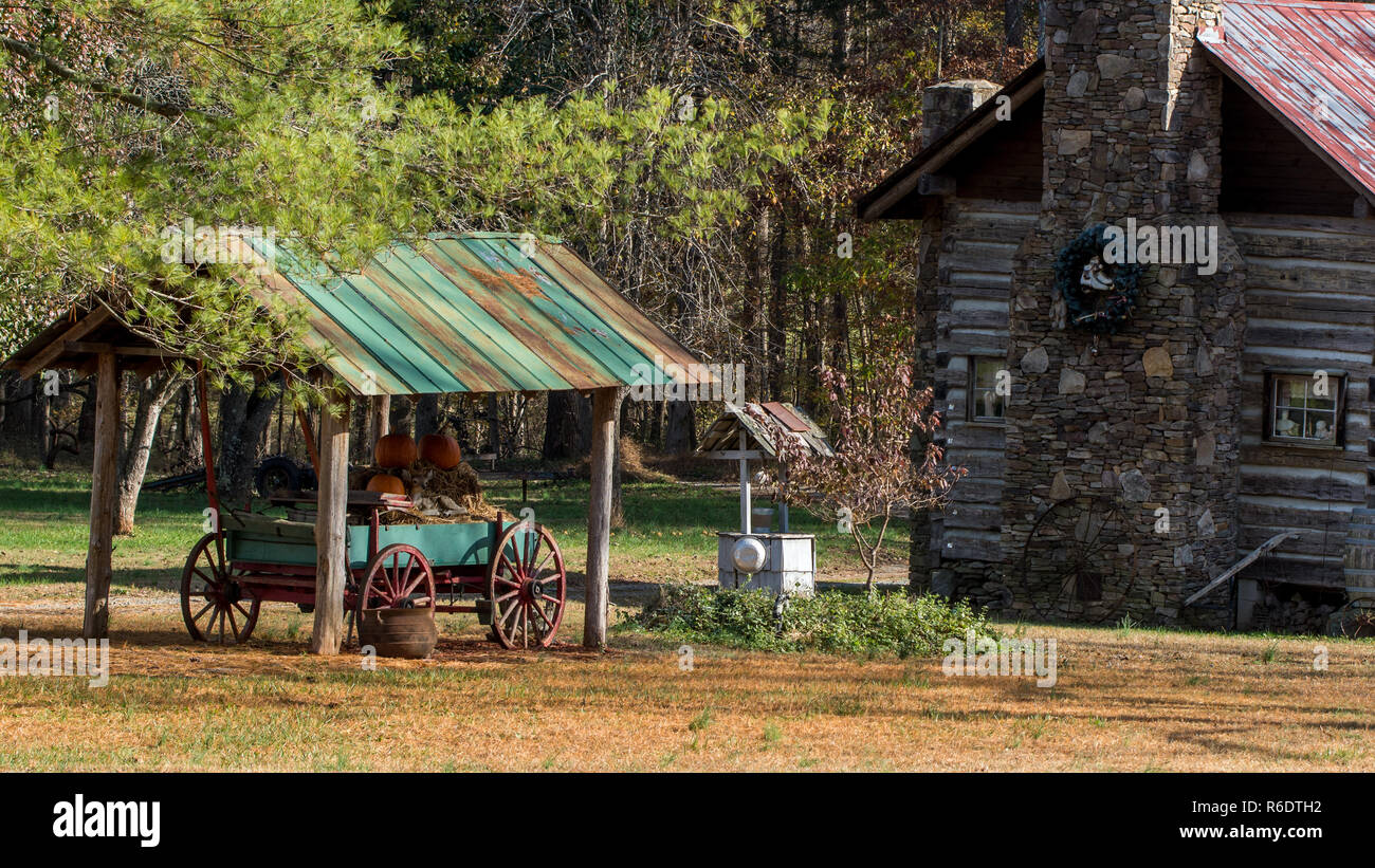 Log Cabin With Wagon Horse Drawn Wagon Under Open Shed Stock Photo