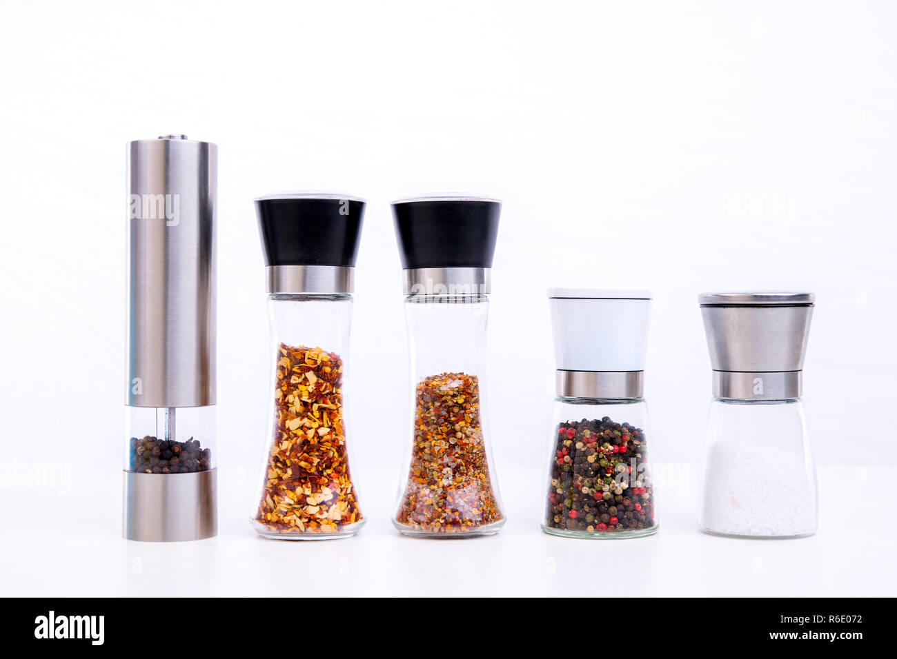 different spice mills with salt,pepper and other herbs Stock Photo Alamy