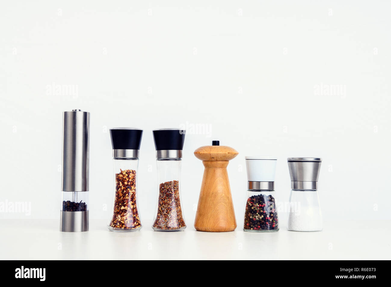 different spice mills with salt,pepper and other herbs Stock Photo Alamy
