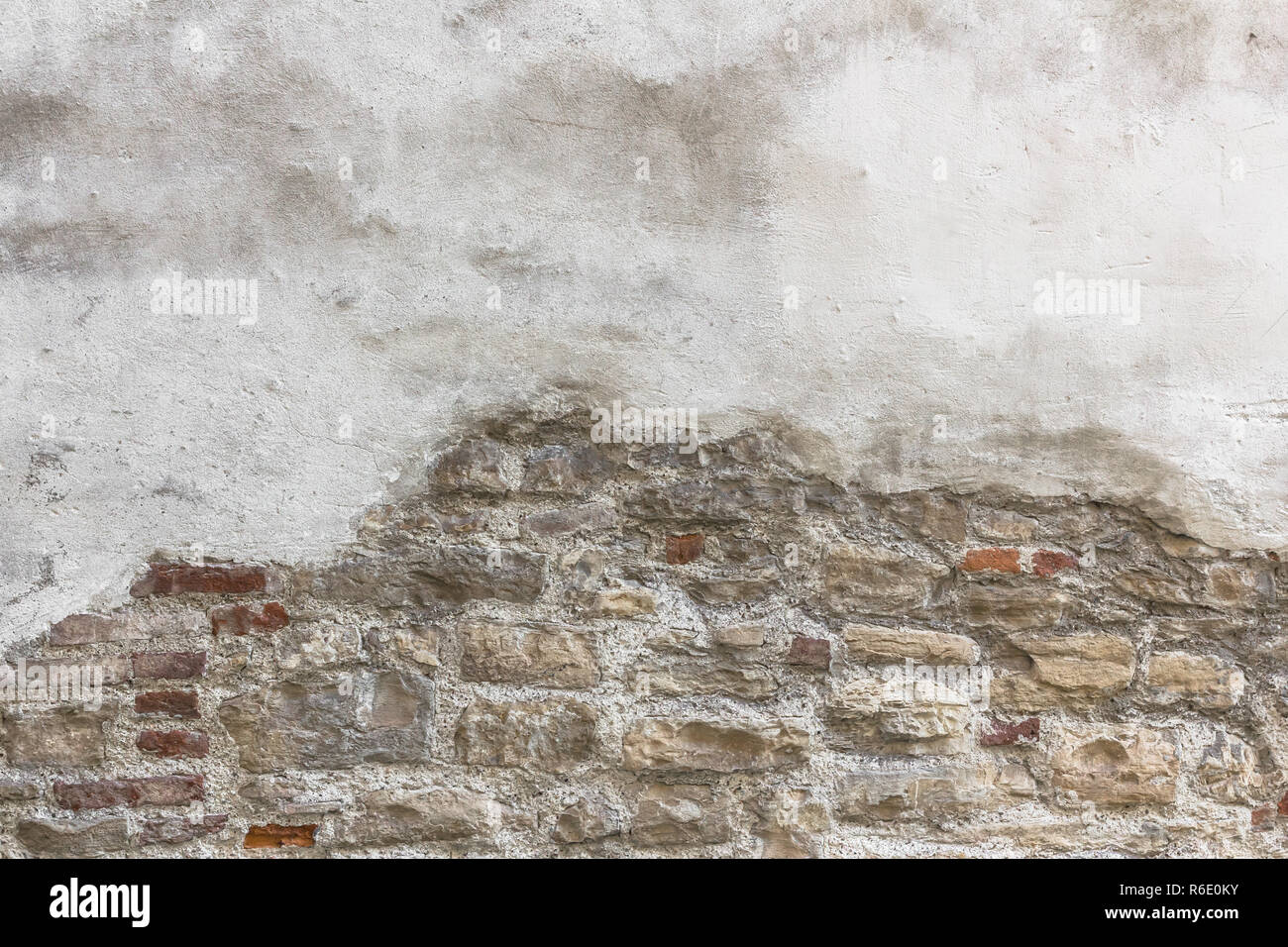 Partially newly plastered brick wall Stock Photo