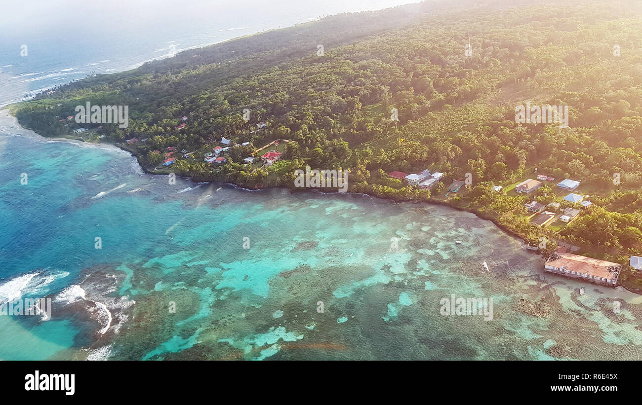 Colorful caribbean island on sunny day aerial drone view Stock Photo