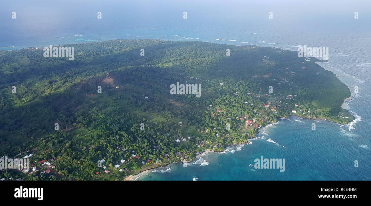 Green island in blue ocean aerial drone view Stock Photo