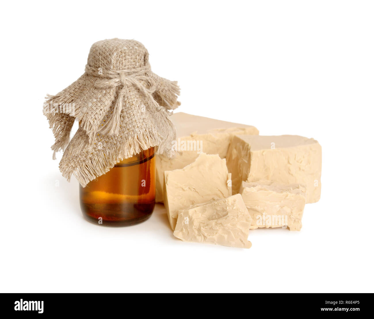 A block of compressed fresh yeast with pharmaceutical bottle. Stock Photo