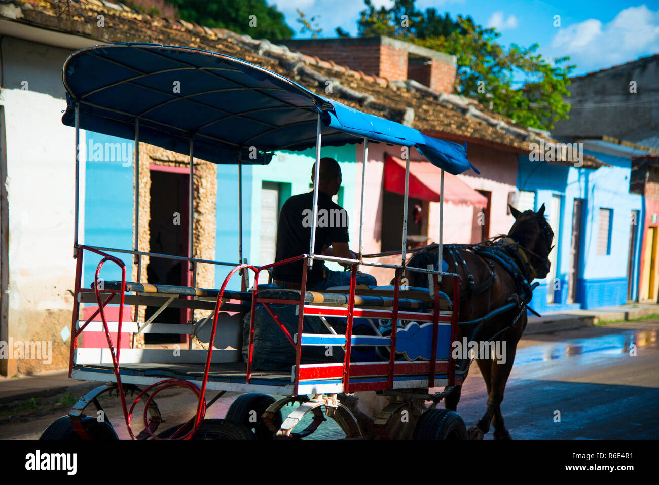 Horse pulling passenger wagon down the street in Trinidad, Cuba. Stock Photo