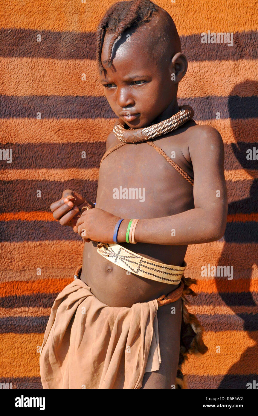 Himba Young Boy With Typical Hairstyle, Omuramba, Kaokoland, Kunene, Namibia Stock Photo