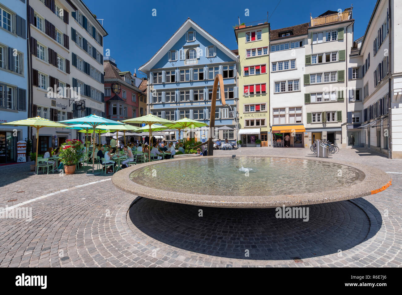 Munsterhof Square With Fountain And Colorful Buildings With Cafe And Restaurants In The Old Town Of Zurich City In Switzerland Stock Photo