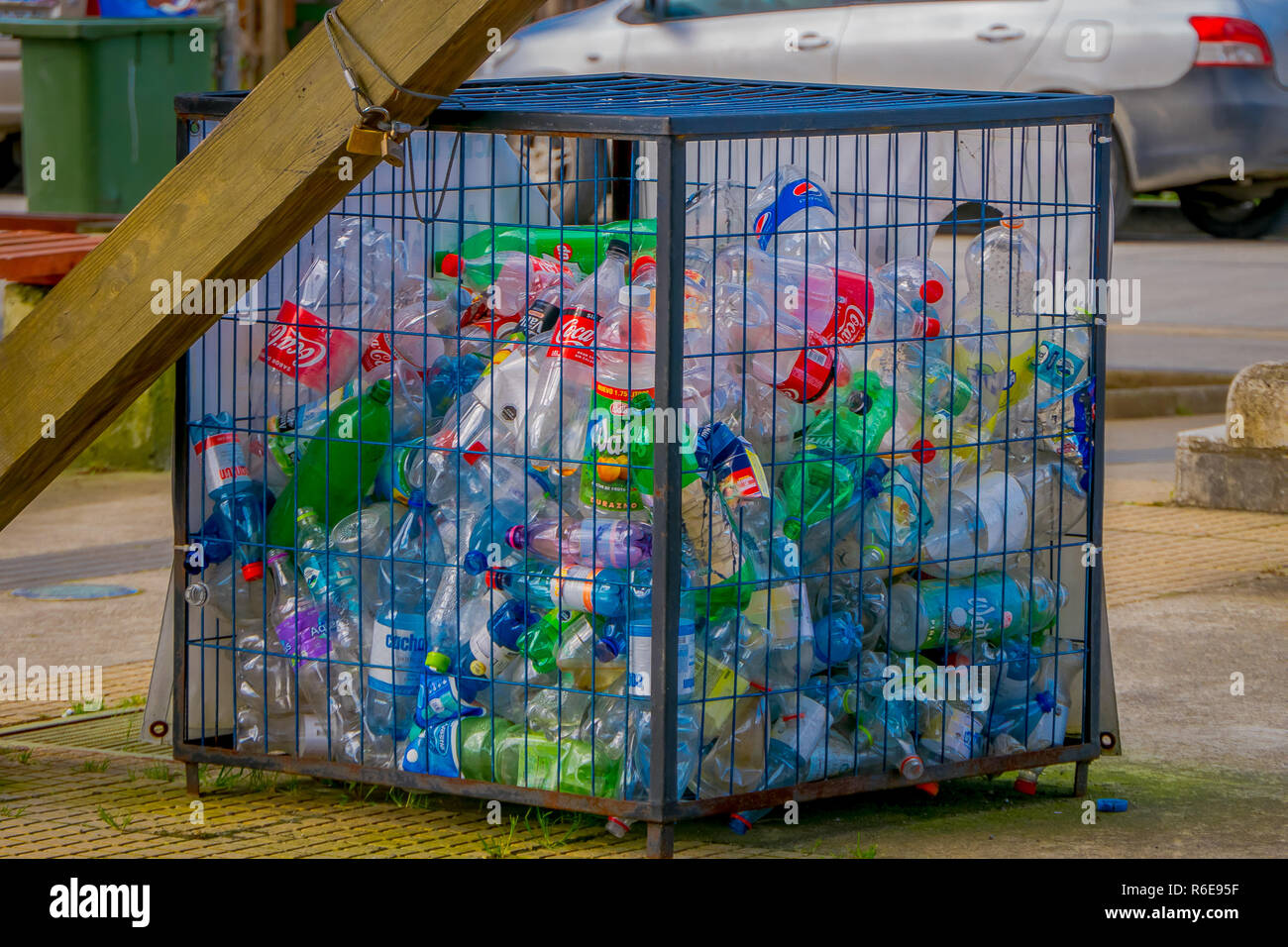 CHILOE, CHILE - SEPTEMBER, 27, 2018: Outdoor view of metallic box with some plastic botlles inside, recycling concept, ecological friendly city located on Lemuy Island Stock Photo