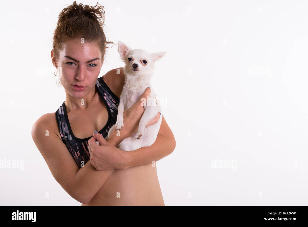 Close up of beautiful teenage girl holding cute dog ready for sp Stock Photo