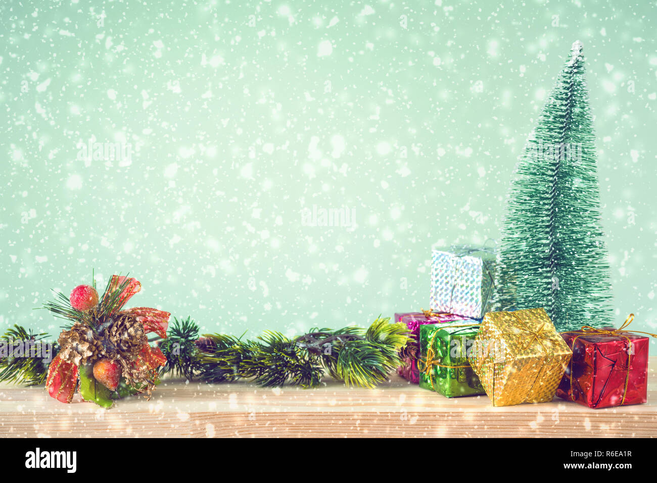 Christmas background. Christmas tree and ornaments lie on a wooden table snowy weather. Space for text. It's snowing. Merry Christmas. New Year's back Stock Photo
