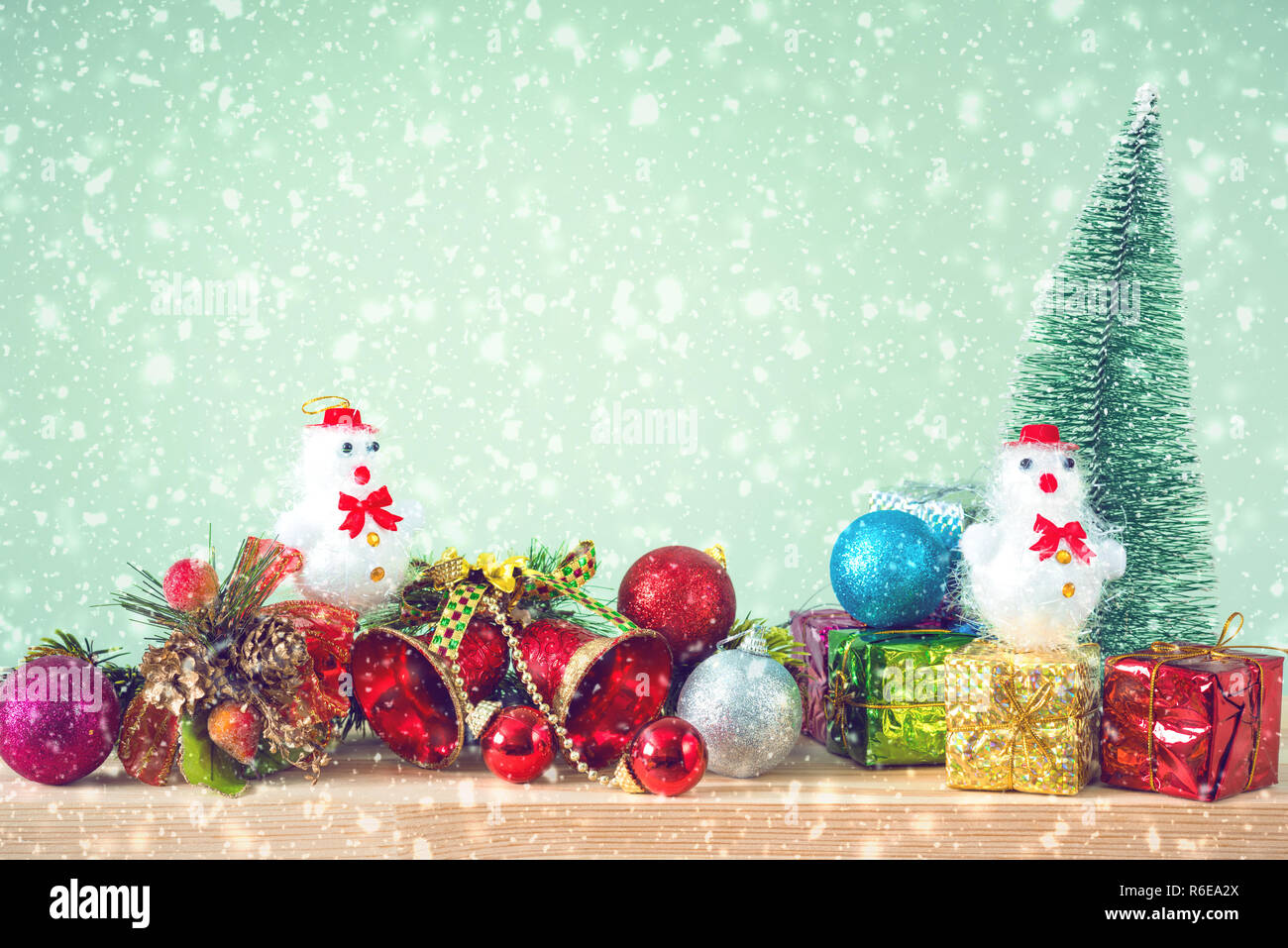 Christmas background. Christmas tree and ornaments lie on a wooden table snowy weather. Space for text. It's snowing. Merry Christmas. New Year's back Stock Photo