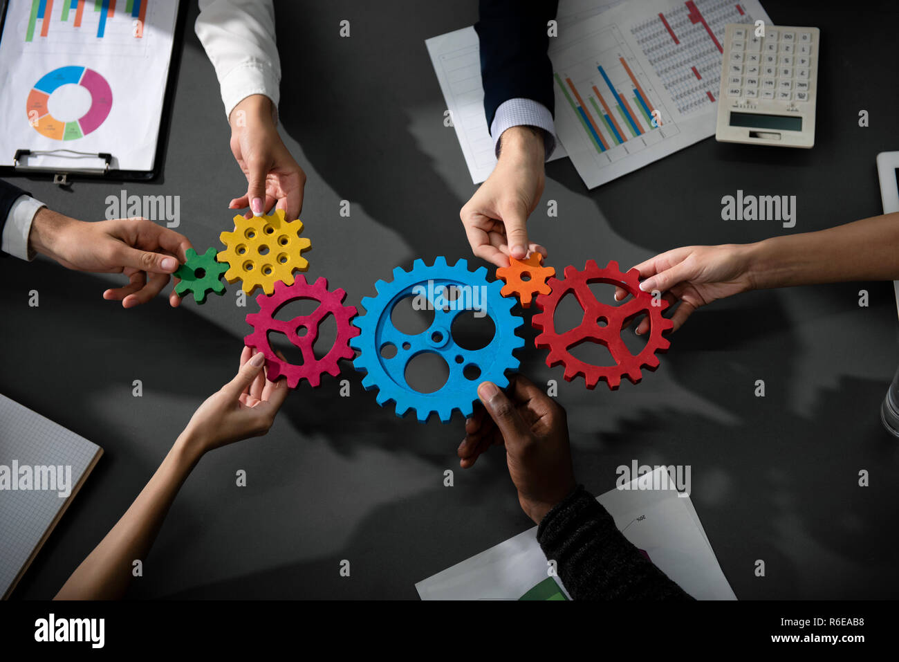 Business team connect pieces of gears. Teamwork, partnership and integration concept Stock Photo
