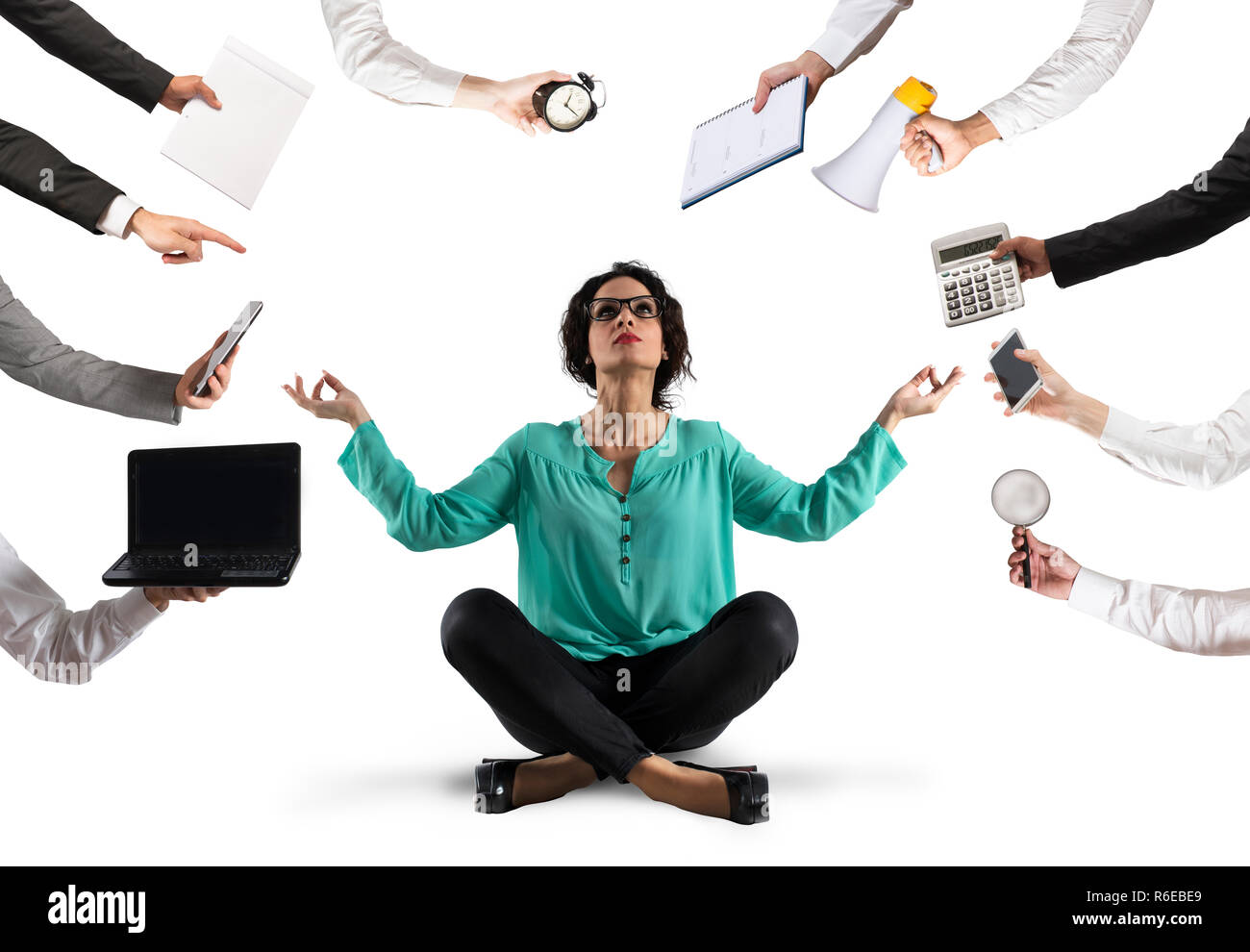 Businesswoman tries to keep calm with yoga due to stress and overwork at wok Stock Photo