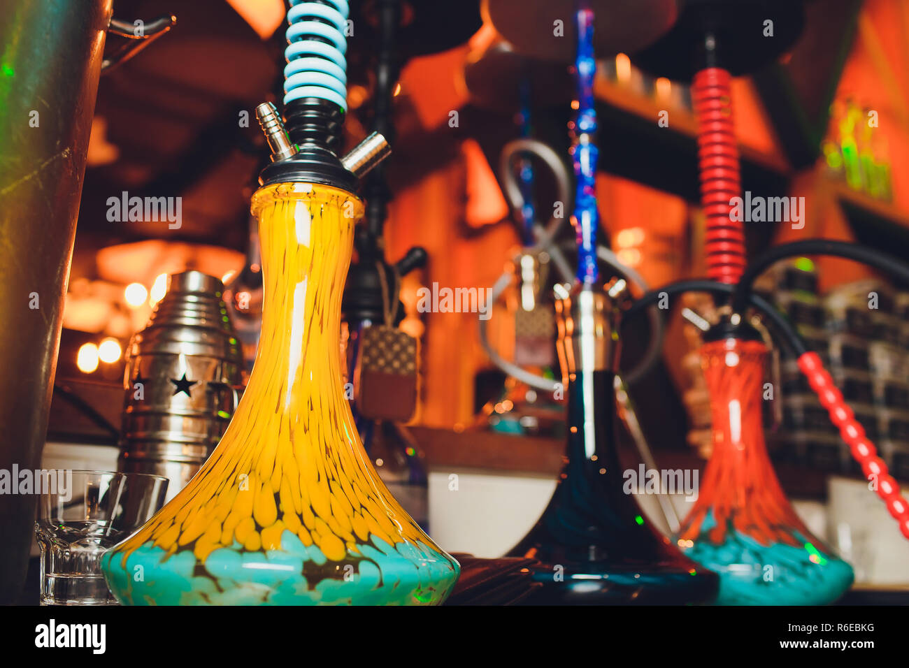 group of red hookahs shisha on table in interior. Stock Photo