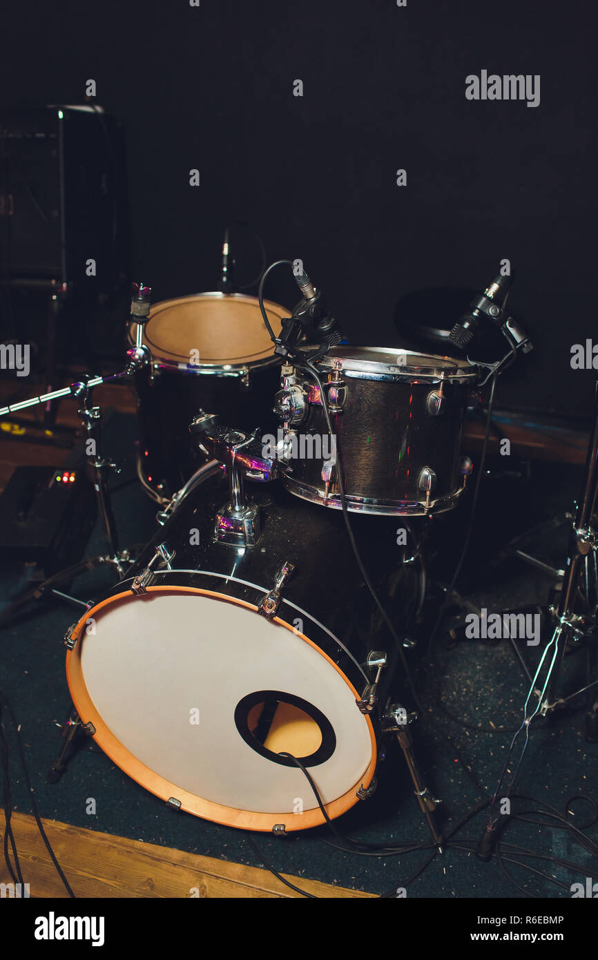Modern drum set shot in smoky dark studio. Stock Photo