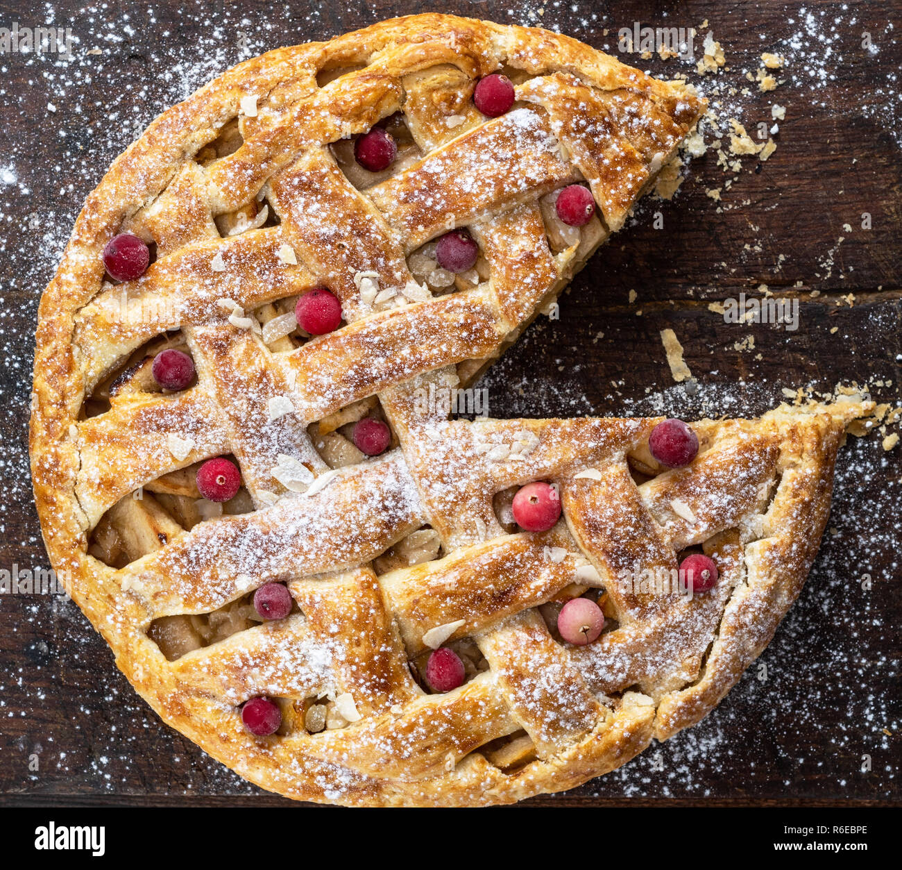 round baked apple pie, cut into a triangular piece, top view Stock ...