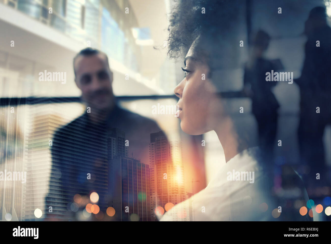 Businesswoman at the office looks through the window for the future. double exposure Stock Photo