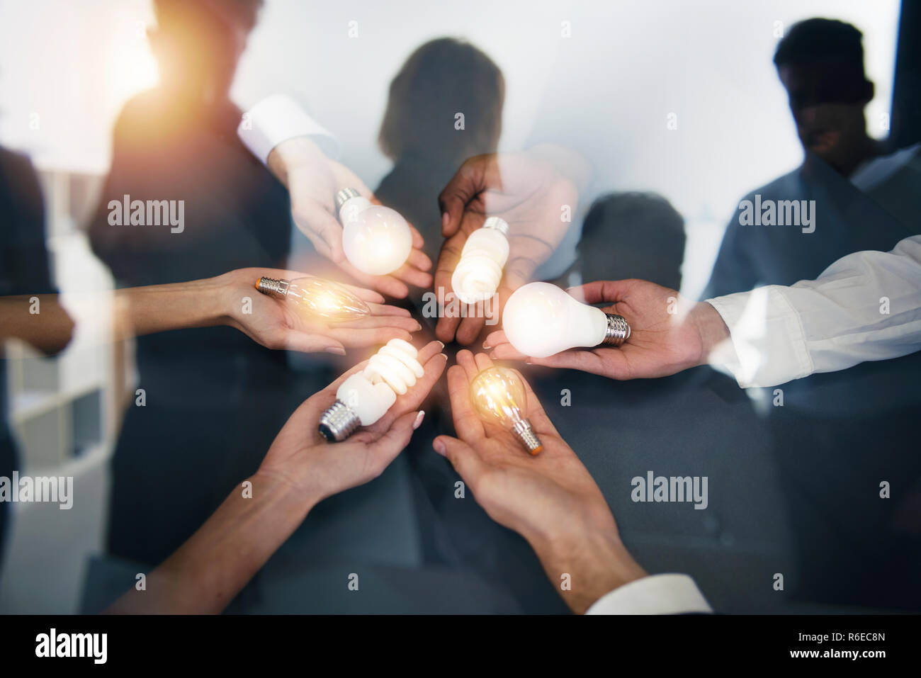 Teamwork and brainstorming concept with businessmen that share an idea with a lamp. Concept of startup. Double exposure Stock Photo