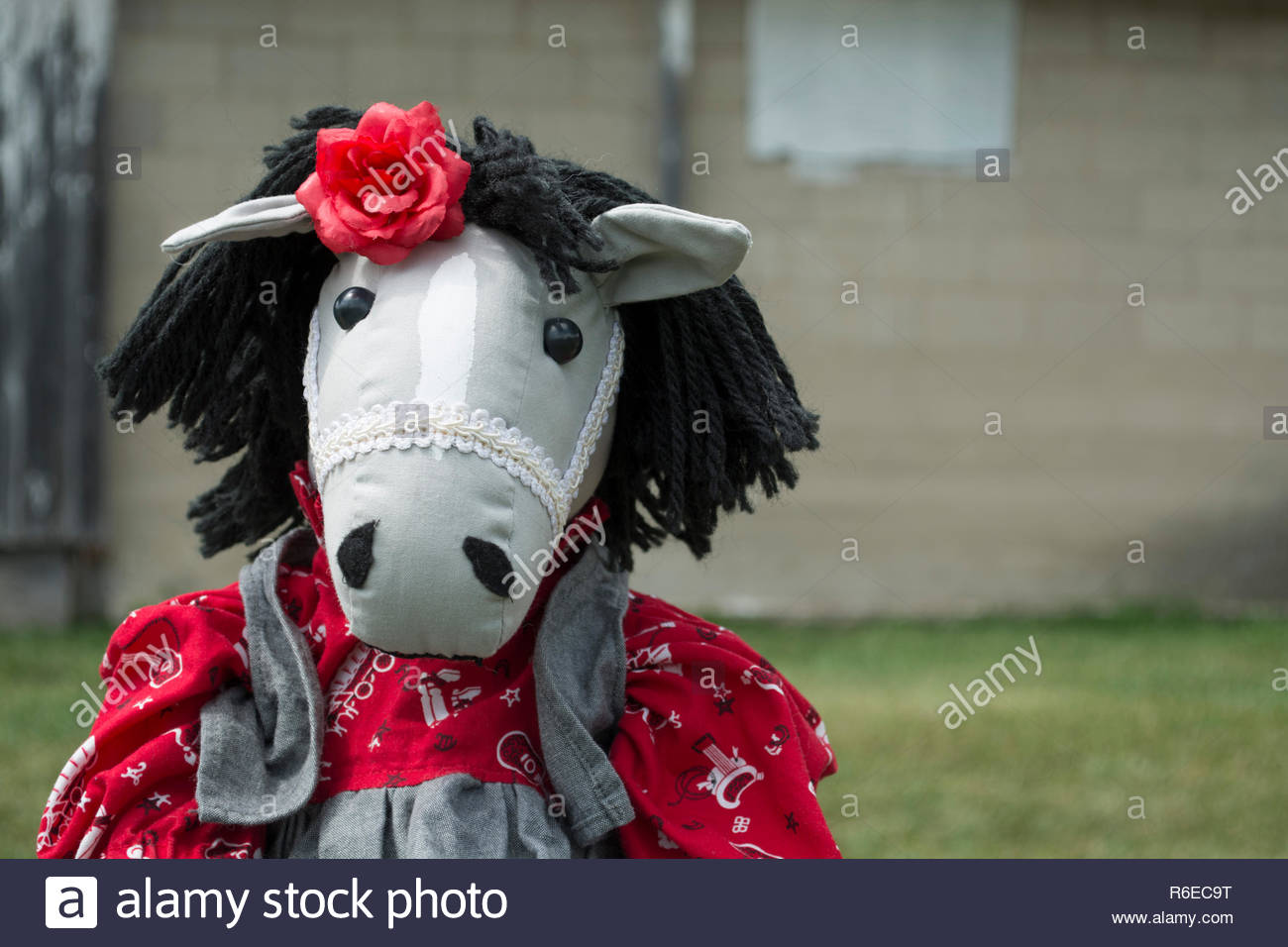 An Adorable Stuffed Horse Toy Wearing Western Themed Clothes Is