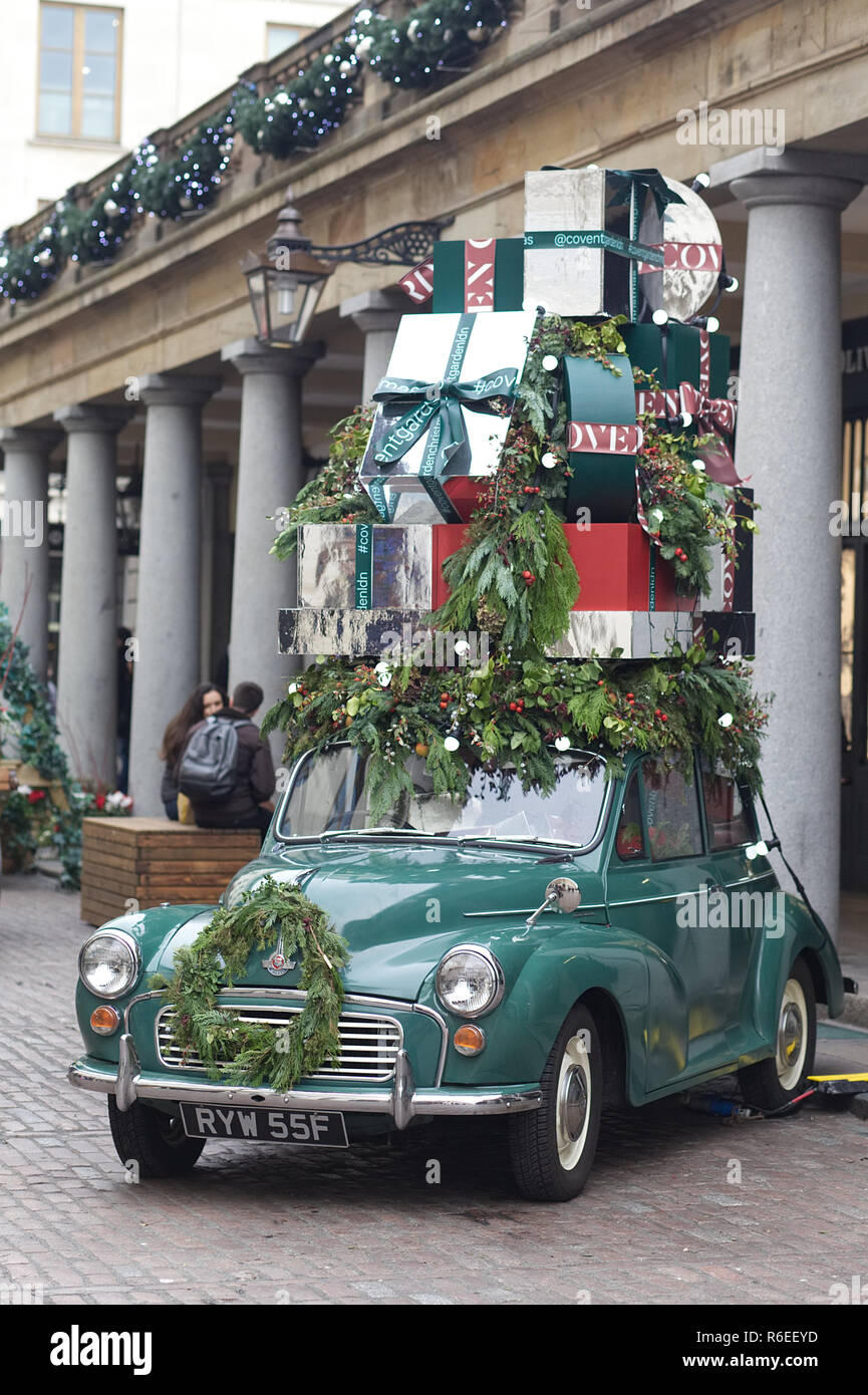 Classic Morris Minor car, decorated with Christmas presents on the roof ...