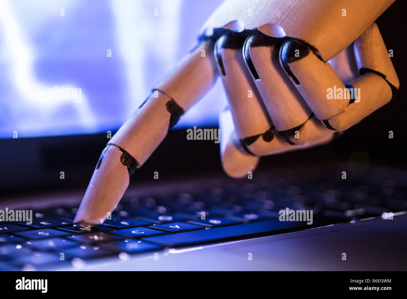 Robot Typing On Laptop Stock Photo