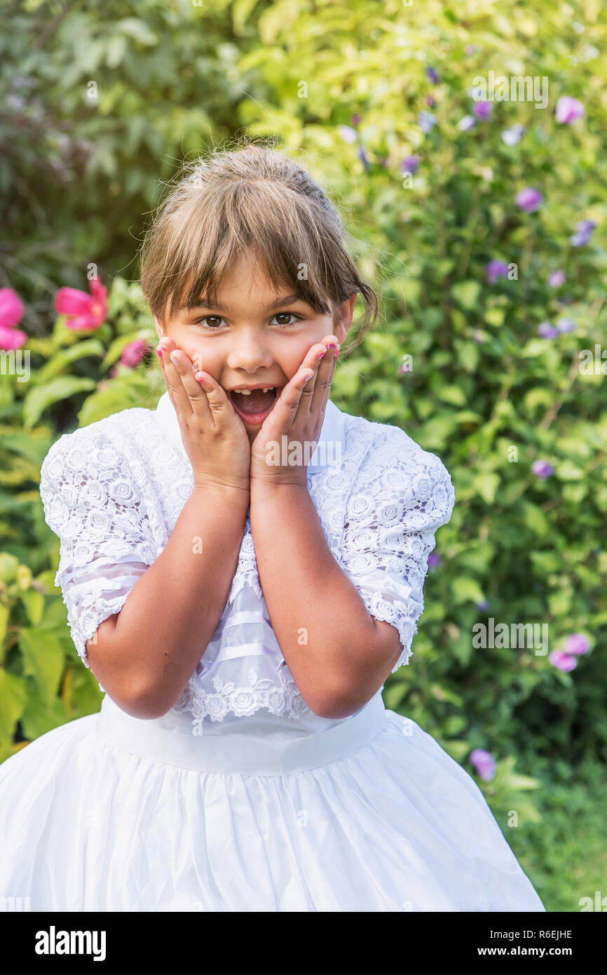 Portrait of surprised little girl in white bridesmaid clothes Stock ...