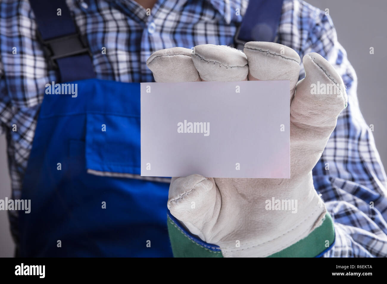 Workman Hands With Gloves Showing Blank Card Stock Photo - Alamy