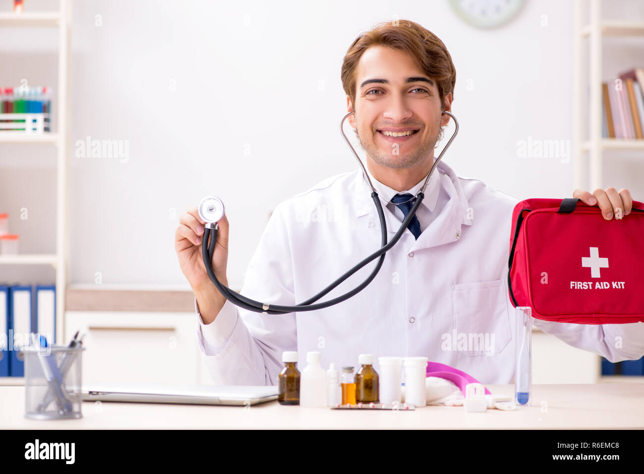 Young doctor with first aid kit in hospital Stock Photo - Alamy