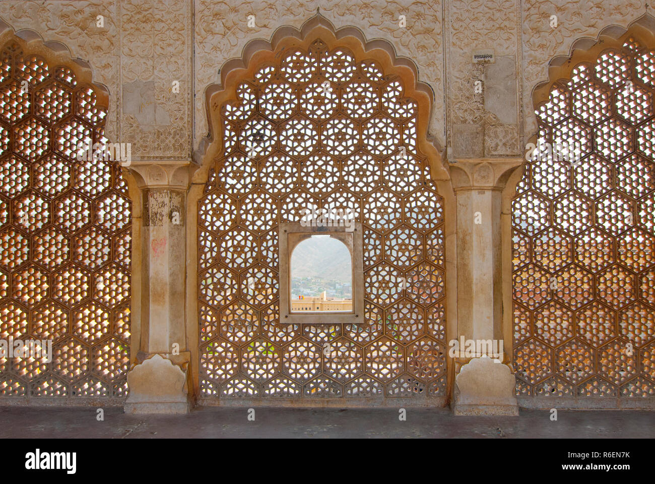 Looking Through Stone Lattice Window To The Walls Of Amber Fort Stock Photo