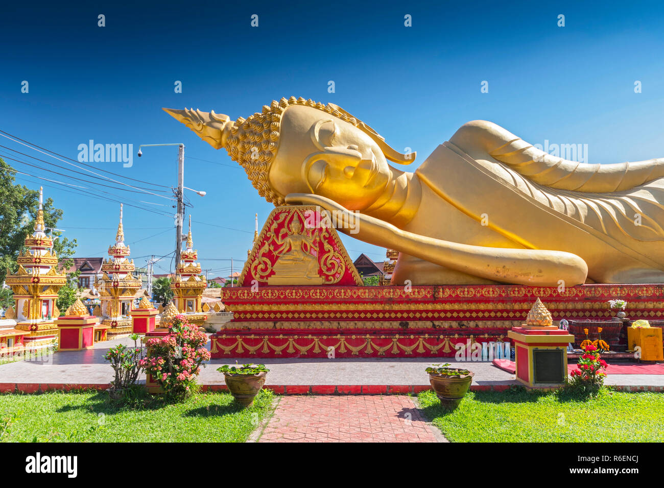 Giant Gold Reclining Sleeping Buddha Statue Near Wat That Luang Temple, Vientiane, Laos Stock Photo