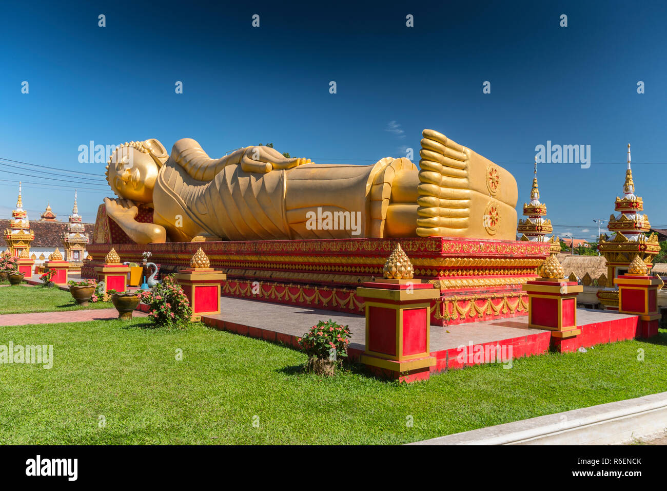 Giant Gold Reclining Sleeping Buddha Statue Near Wat That Luang Temple, Vientiane, Laos Stock Photo