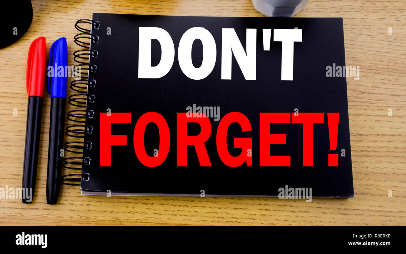 Conceptual hand writing text caption showing Do Not Forget. Business concept for Reminder Message written on sticky note with space on old wood wooden background with sunglasses Stock Photo