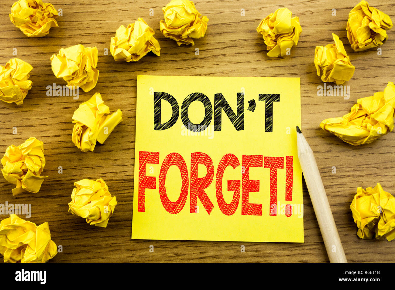 Word, writing Do Not Forget. Business concept for Reminder Message written on sticky note paper on the wooden background. Folded yellow papers on the background Stock Photo