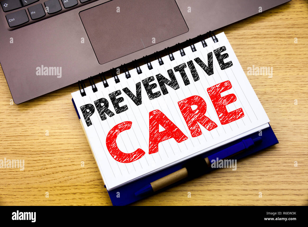 Hand writing text caption inspiration showing Preventive Care. Business concept for Health Medicine Care written on notebook book on the wooden background in the Office with laptop Stock Photo