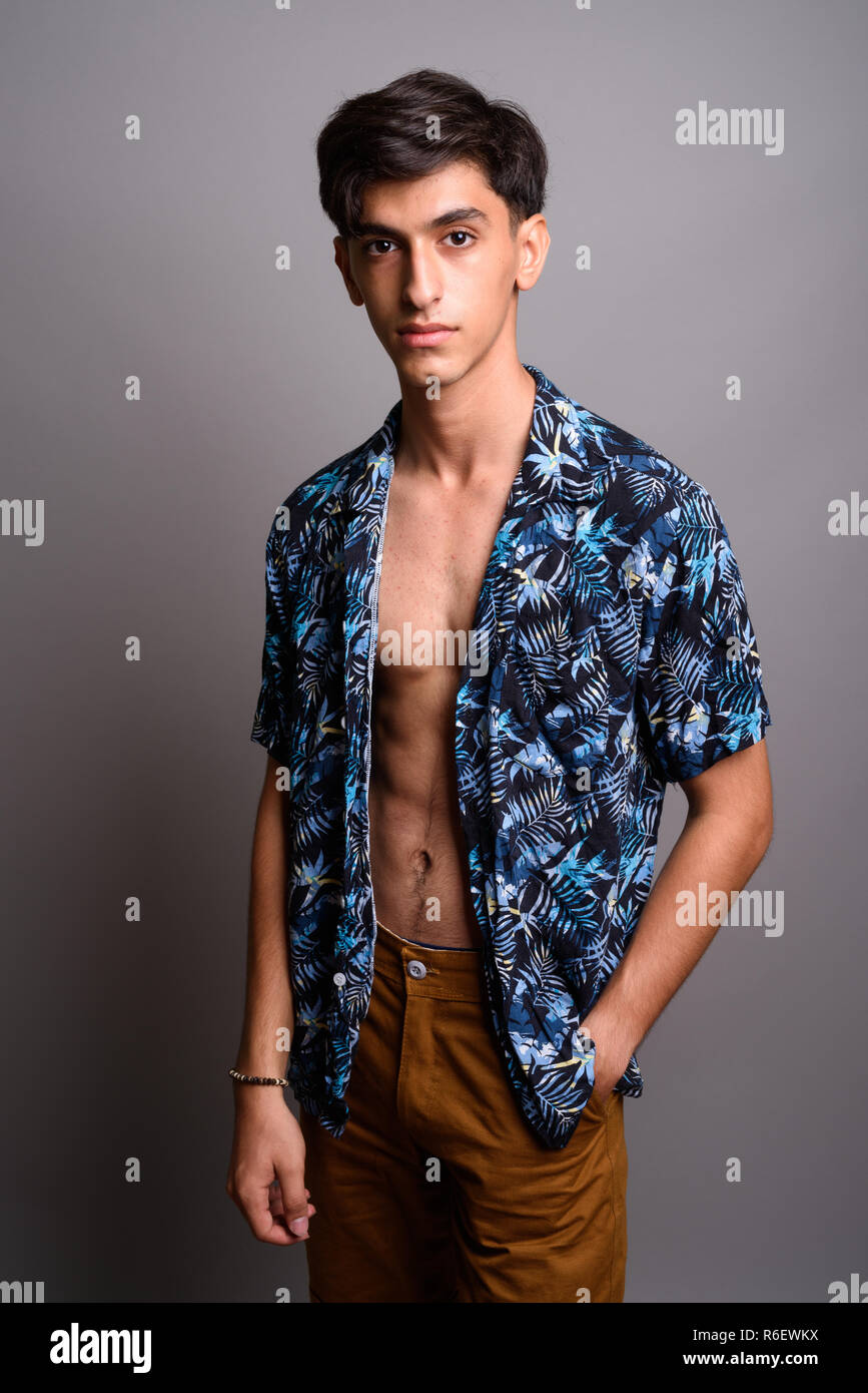 Young handsome Persian teenage boy wearing Hawaiian shirt agains Stock  Photo - Alamy