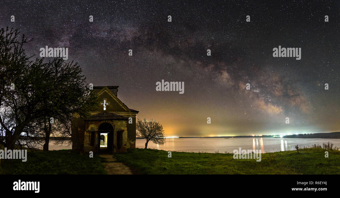 Milky way panorama over an abandoned church in Romania Stock Photo