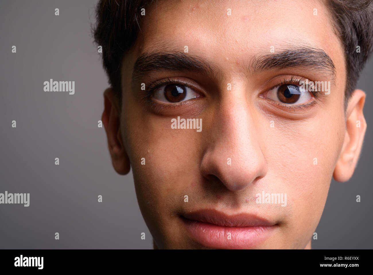 Close up of young handsome Persian teenage boy face Stock Photo