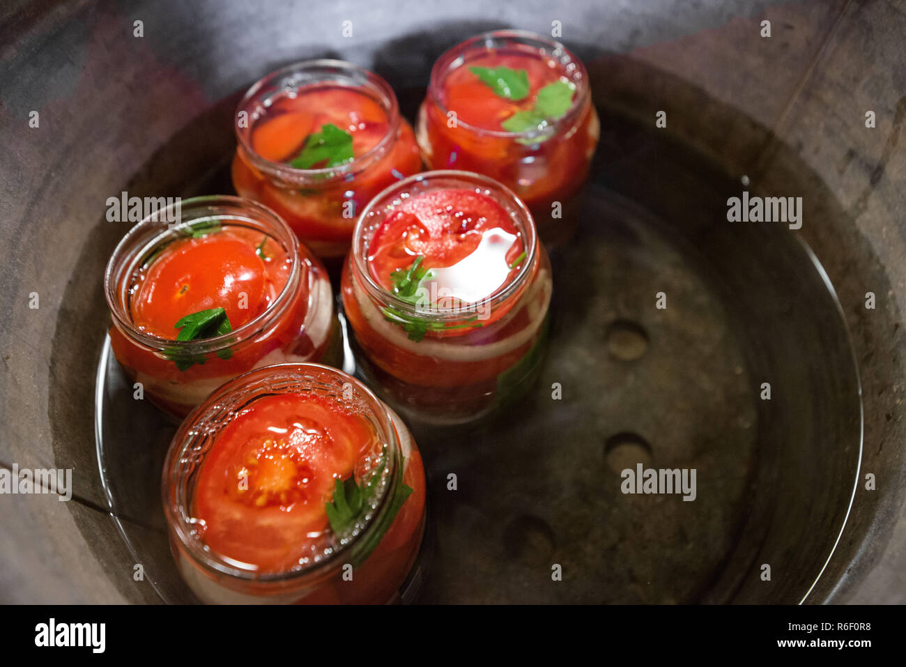 Canning fresh tomatoes with onions in jelly marinade. Conservation and