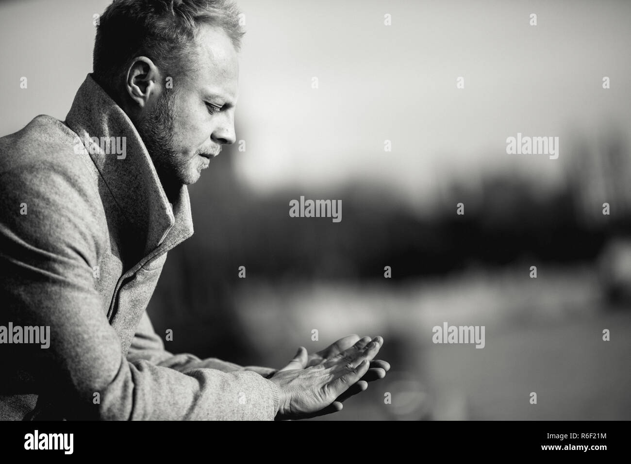 Black and white photo at side of man in coat for walk . Stock Photo