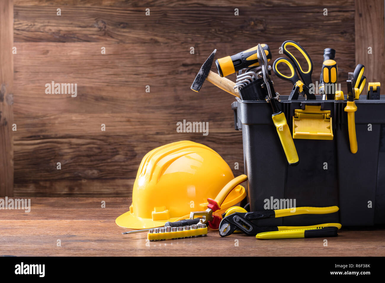 Safety Helmet With Tools In The Black Container Stock Photo