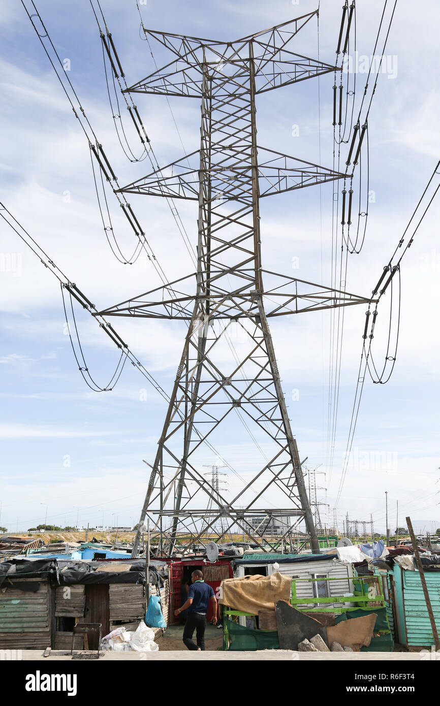 Cape Town South Africa 28th Dec 2013 A man walks in to a shack under power lines in one of Cape towns Informal settlement. Stock Photo