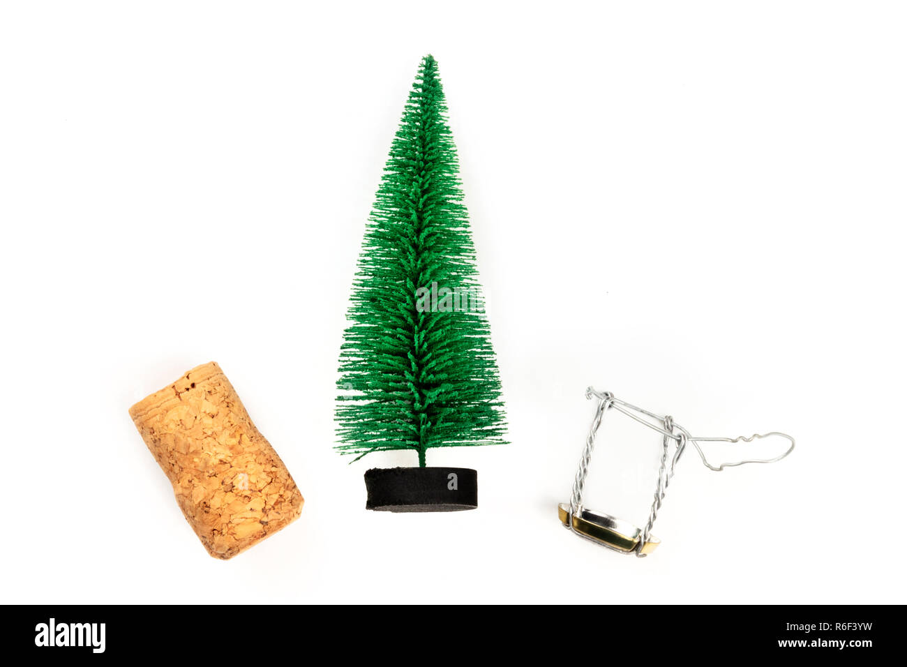 A photo of a little Christmas tree with a champagne cork and closure, shot from above on a white background with copy space Stock Photo