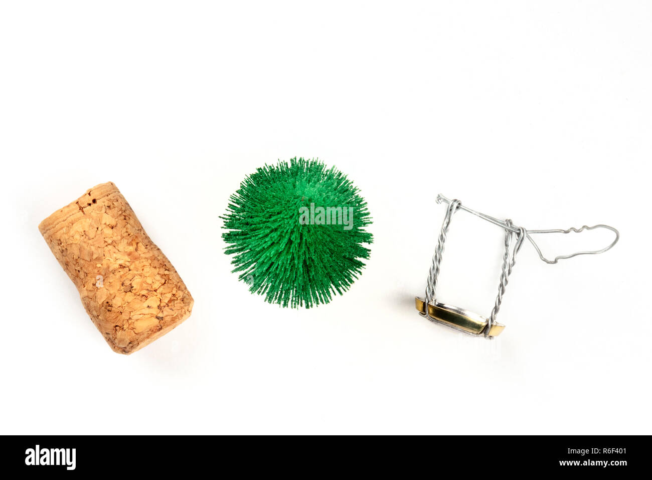 A photo of a little Christmas tree with a champagne cork and closure, shot from the top on a white background with a place for text Stock Photo