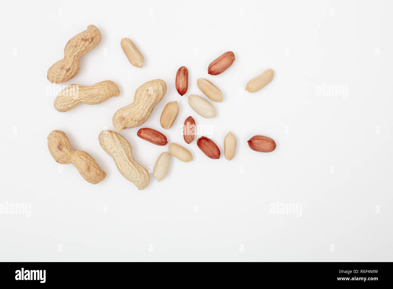 Raw peanuts , shelled, husk, whole, halves , Pattern of nuts form. isolated on white background, top view Stock Photo