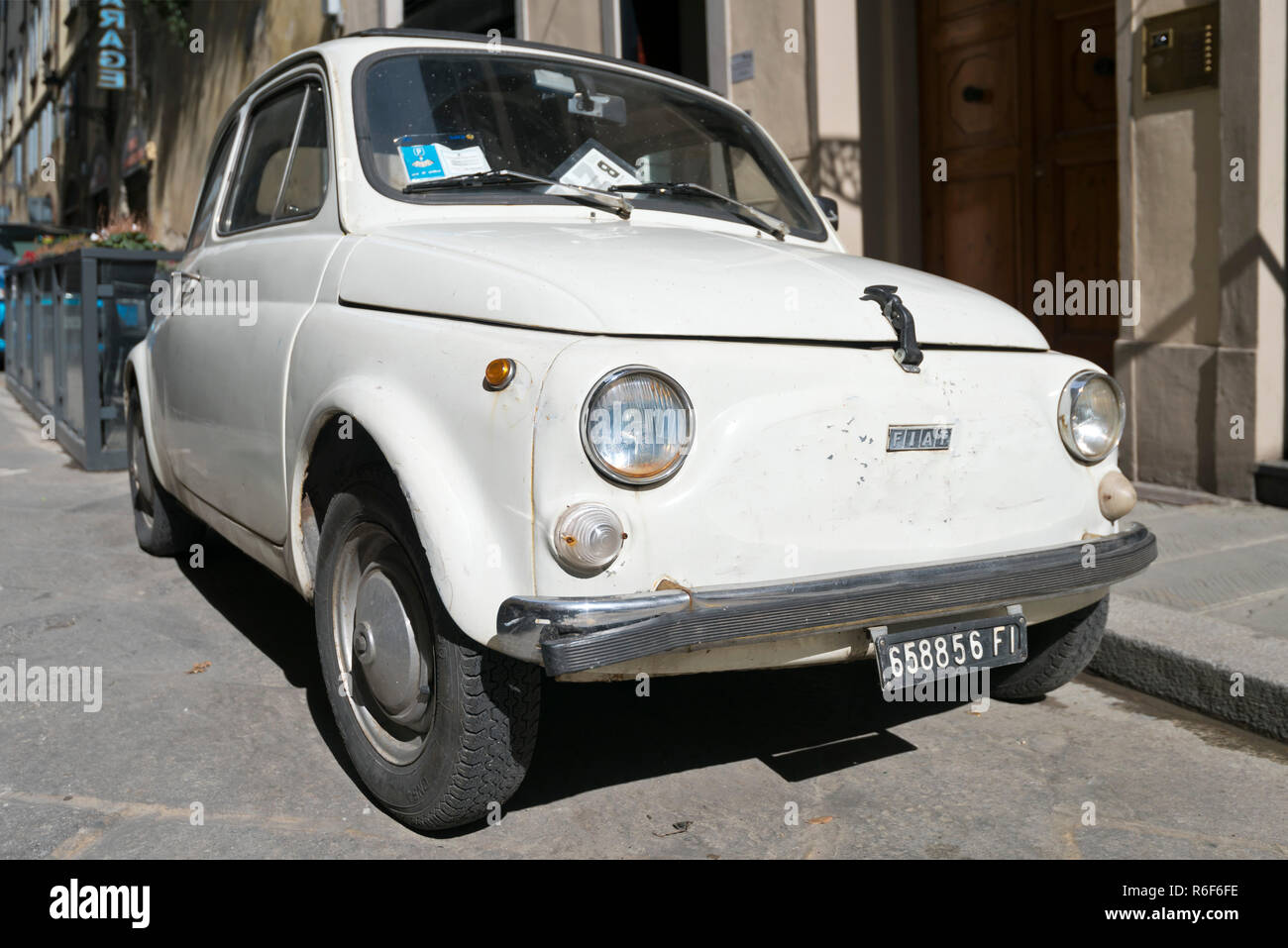 Horizontal close up of a dilapidated old Fiat 500 parked in Italy. Stock Photo