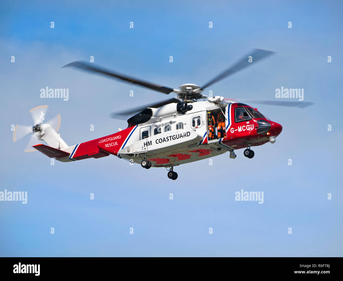 Horizontal close up of a coastguard helicopter in flight. Stock Photo