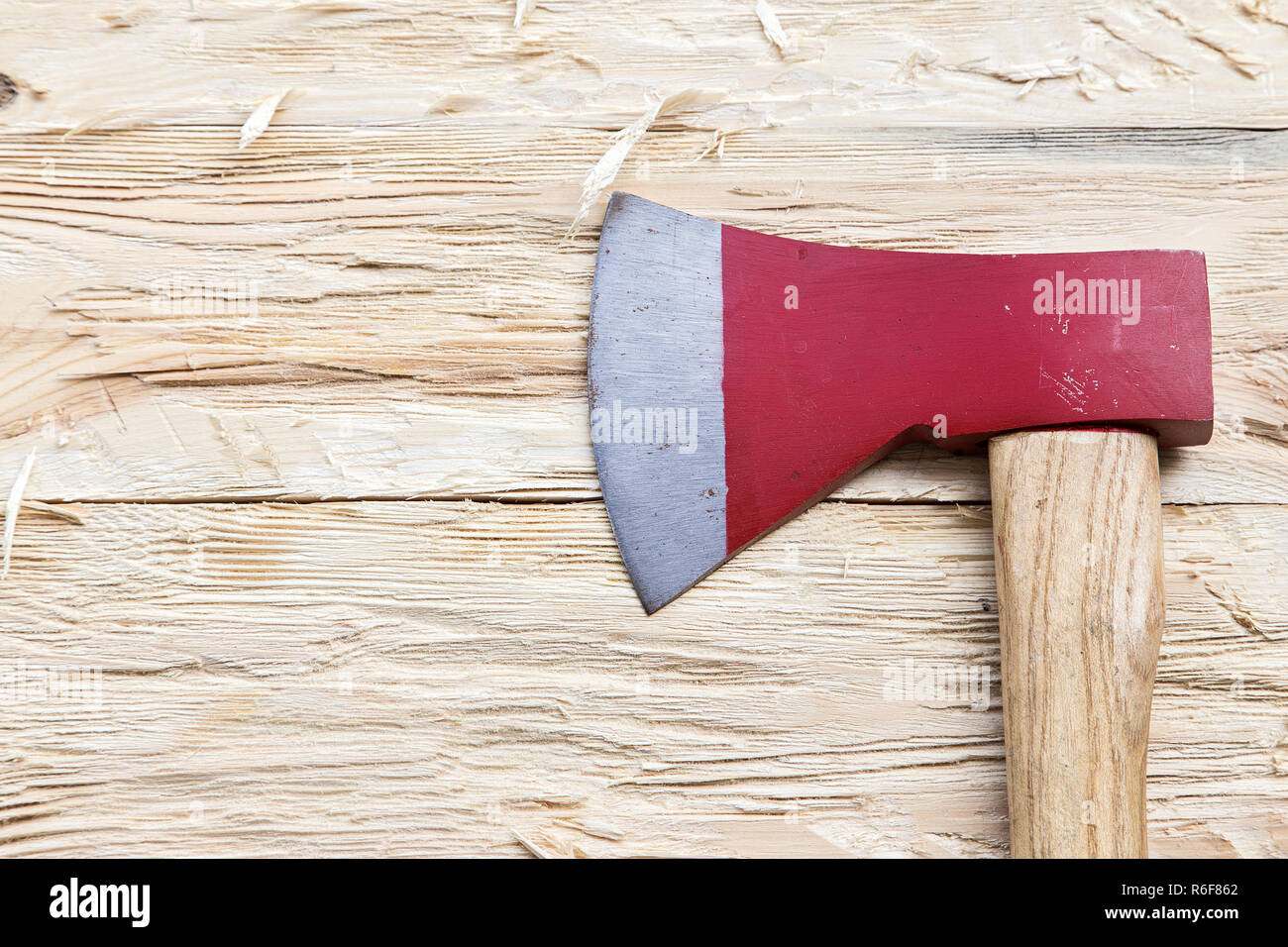 Red ax on a wooden background, top view Stock Photo - Alamy