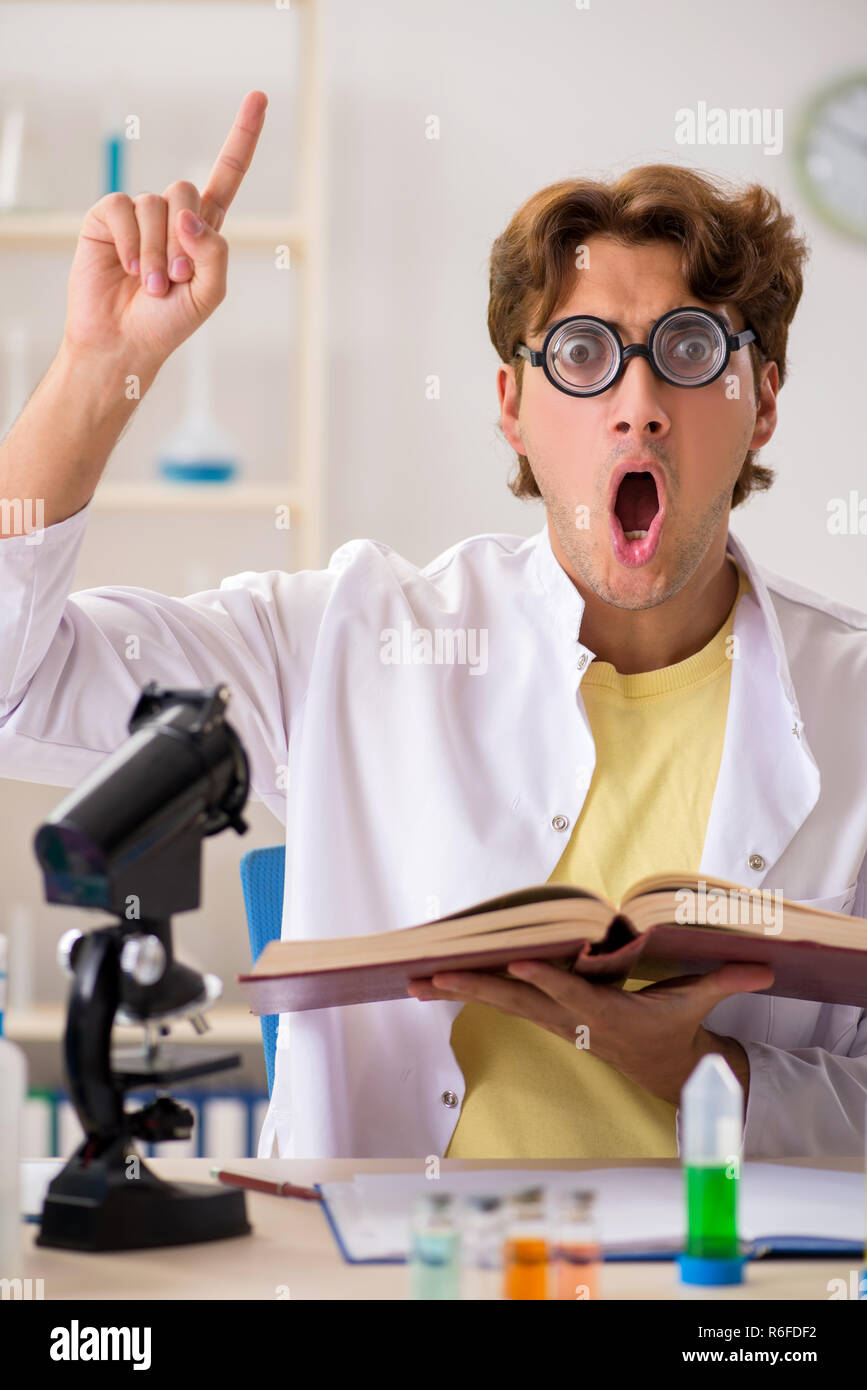 Funny crazy chemist doing experiments and tests Stock Photo