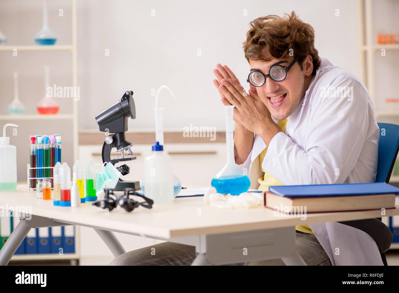 Funny crazy chemist doing experiments and tests Stock Photo