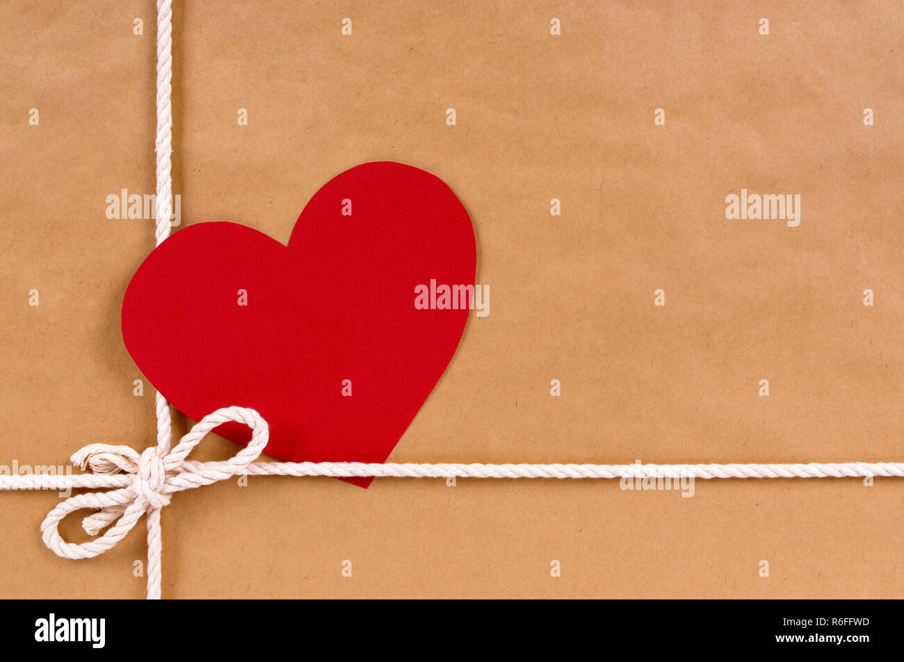 Valentine gift with gift tag, brown paper package parcel background, copy space Stock Photo