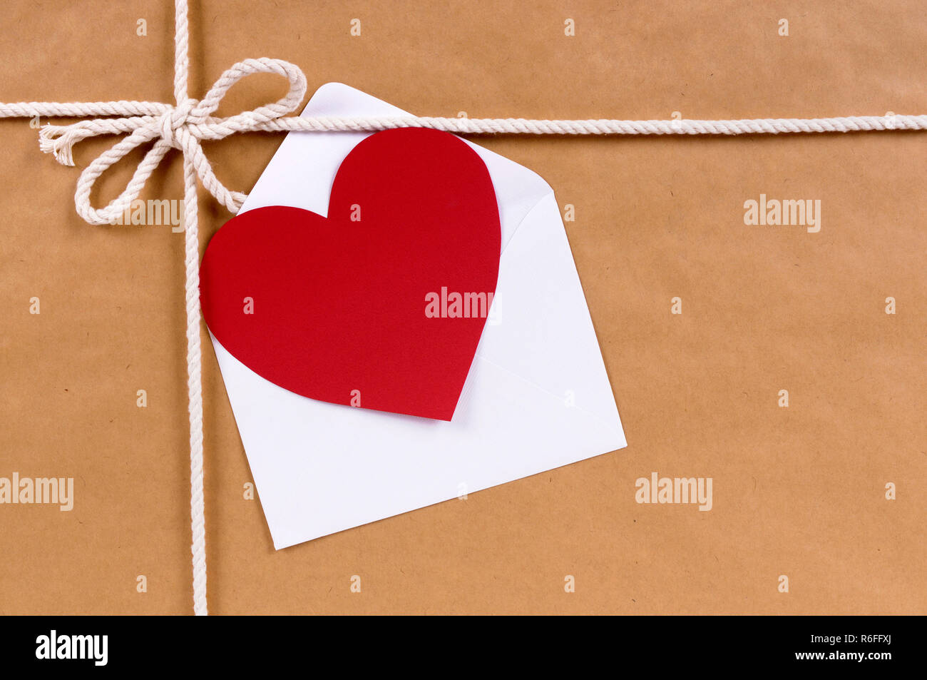 Valentine card or gift tag, brown paper package or parcel, copy space Stock Photo